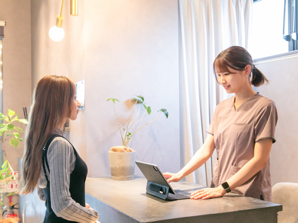 笑顔で受付をするスタッフ
